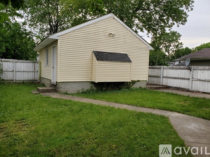 A small house with a white fence in front.
