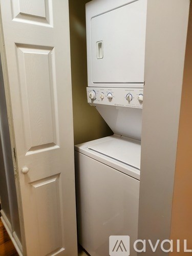 A white washing machine and dryer in a small laundry room.