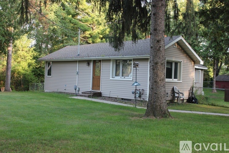 A house with a brown door and a brown roof.