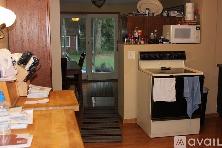 A kitchen with a wooden table and a black oven.