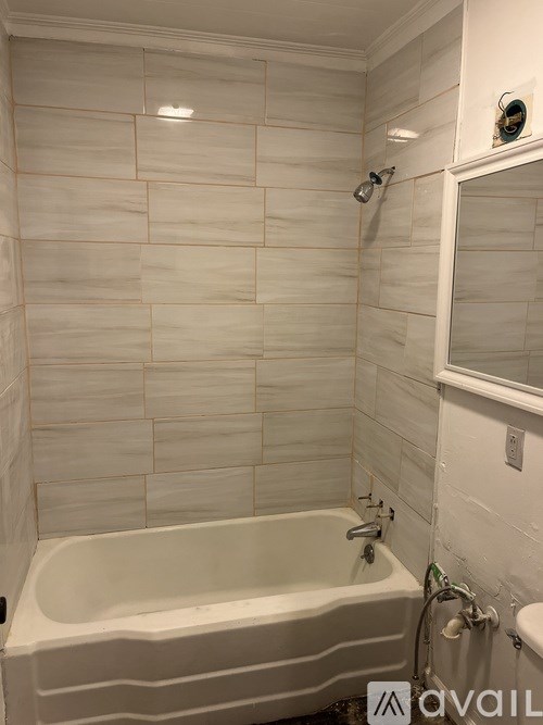 A white bathroom with a tub and a shower.