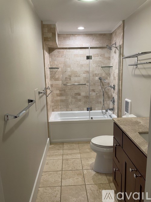 A bathroom with a tiled shower and a toilet.