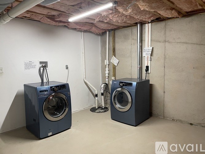 Two washing machines in a laundry room.