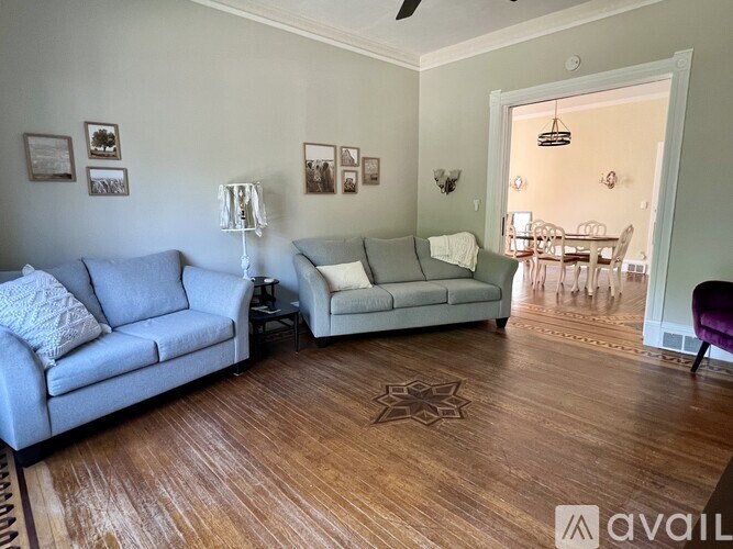 A living room with a grey couch and a white couch.