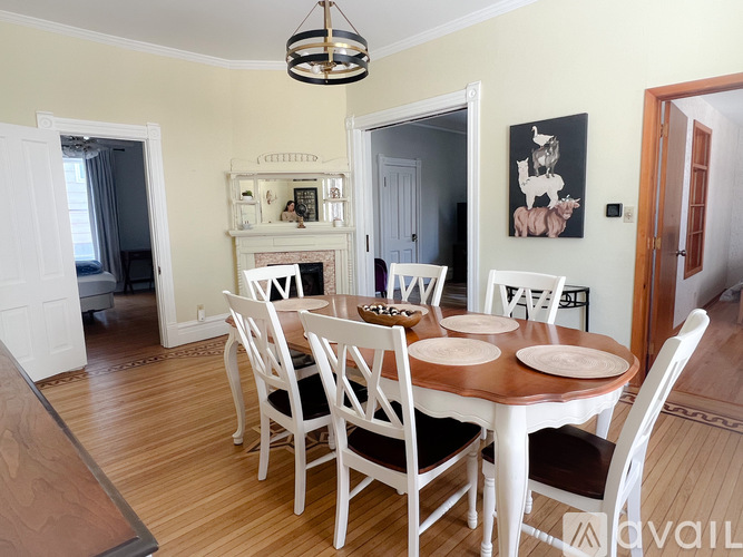 A dining room with a round table and chairs.