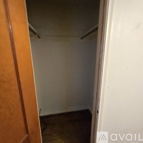 A small, empty room with a wooden door.