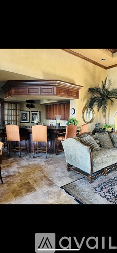 A living room with a couch and a dining table.