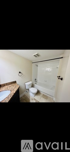 A bathroom with a toilet, sink, and shower.