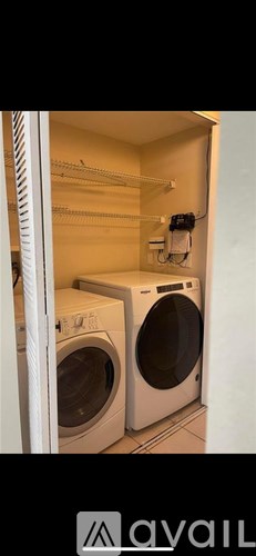 A small laundry room with a washer and dryer.