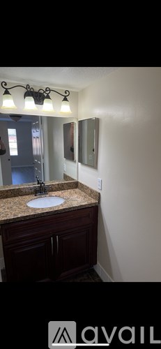 A bathroom with a sink and a mirror.