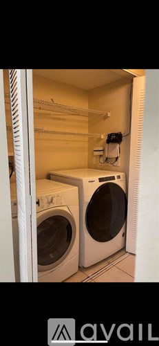 A small laundry room with a washer and dryer.