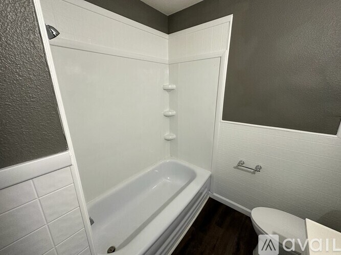 A white bathroom with a bathtub, toilet, and sink.