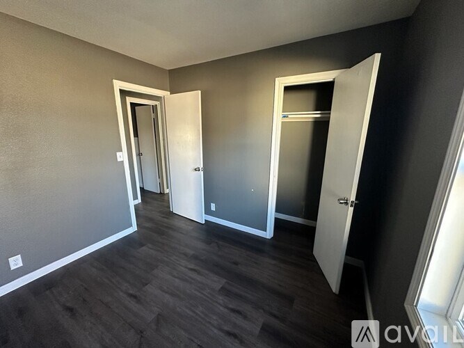 A room with three doors, one of which is open.