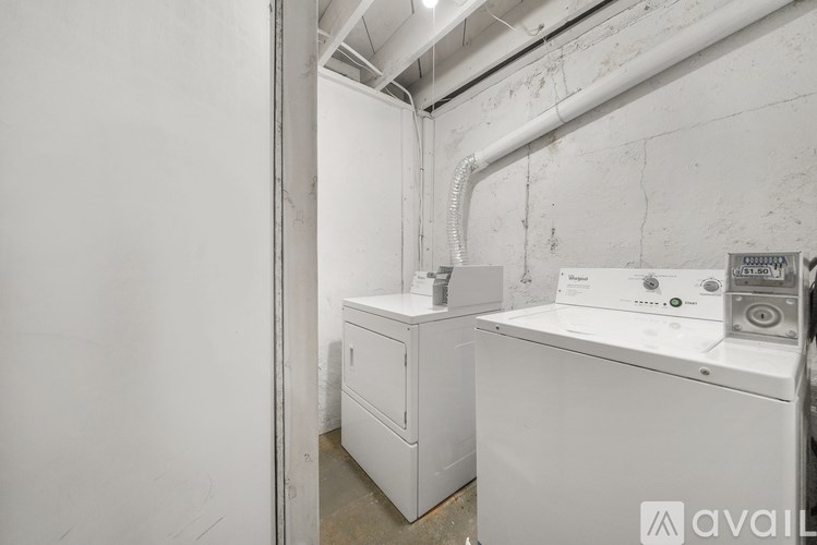 A white washing machine and dryer in a laundry room.