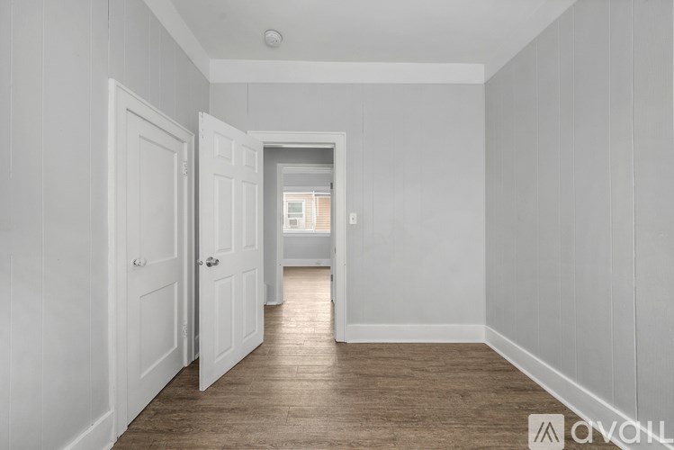 A long hallway with a door on the left and another door on the right.