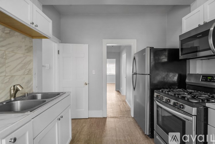 A kitchen with white cabinets and stainless steel appliances.