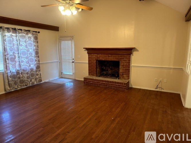 A room with a fireplace and wooden floors.