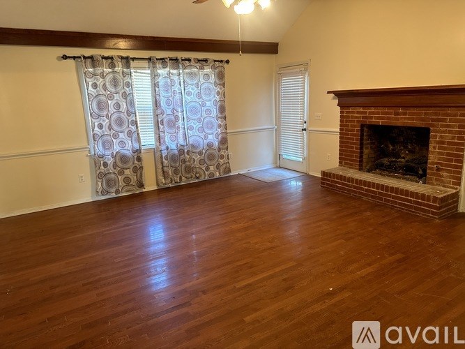 A room with a fireplace and wooden floors.