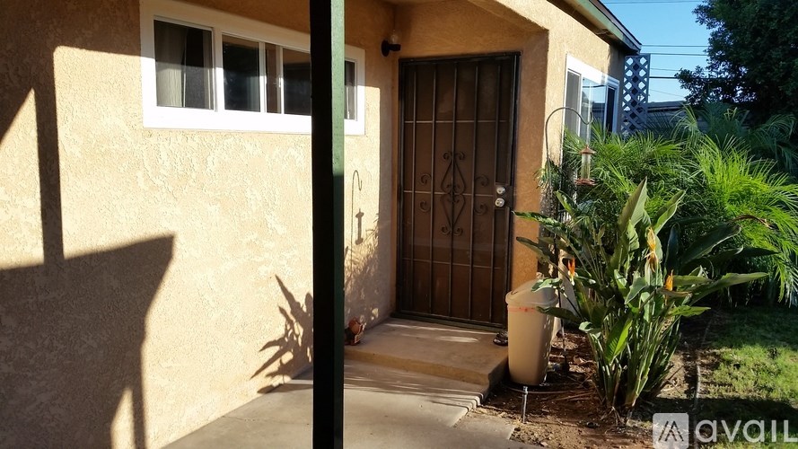 A house with a brown door and a window is shown.