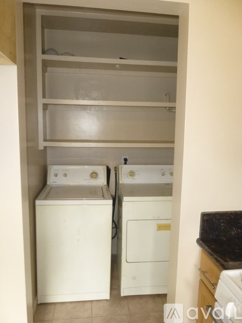 A small laundry room with a washer and dryer.