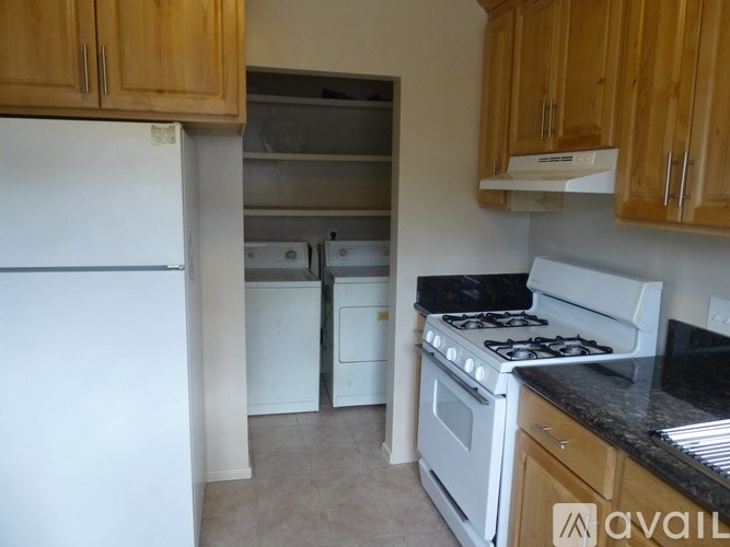 A kitchen with a white fridge, white dishwasher, and white stove.