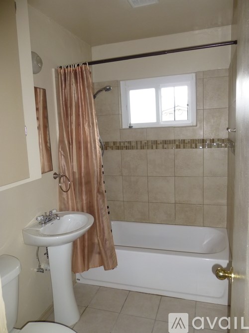 A bathroom with a white sink and a white bathtub.
