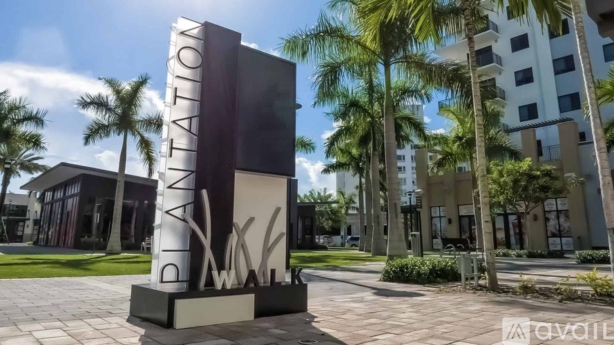 A large sign that says "AVAILATION" stands in front of a building with palm trees.