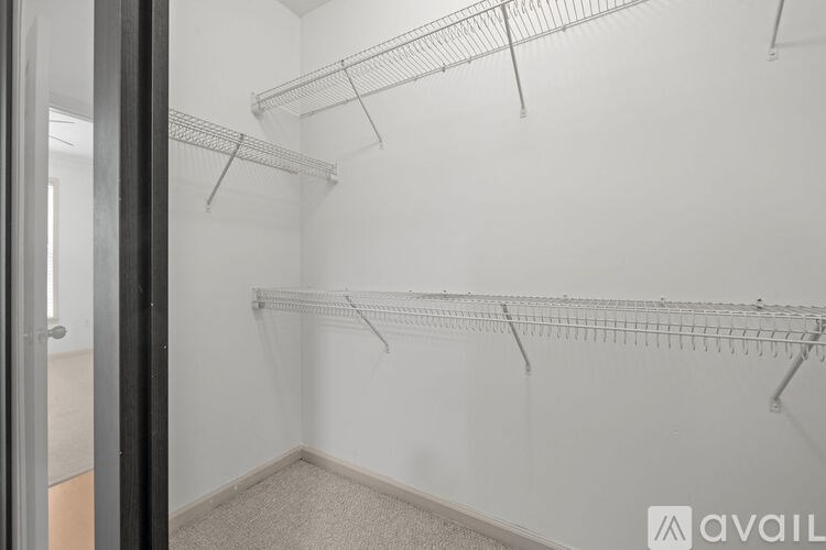 Empty walk-in closet with shelves and a door.