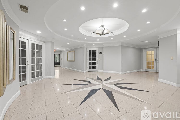 A large, empty room with a star-shaped design on the floor.