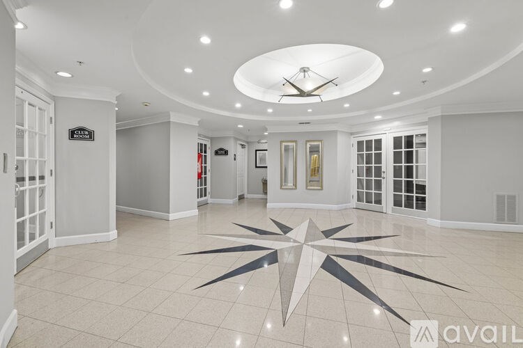 A large, empty room with a star-shaped design on the floor.