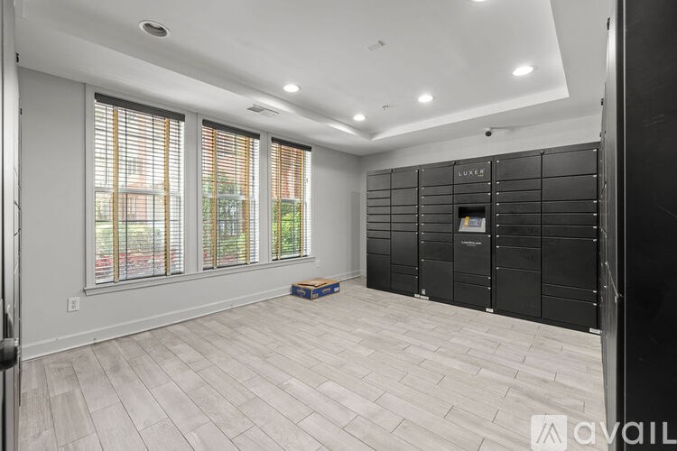 A room with a large window and a wooden floor.