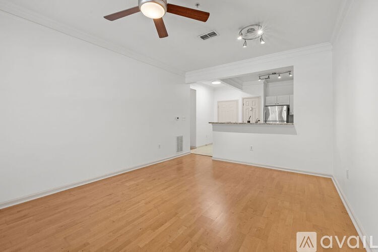 A room with wooden flooring and a ceiling fan.