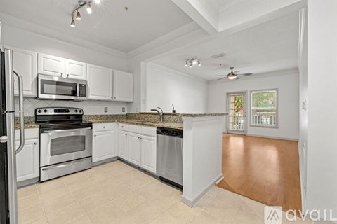 A kitchen with white cabinets and stainless steel appliances.