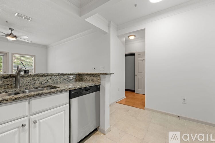 A kitchen with white cabinets and a granite countertop.