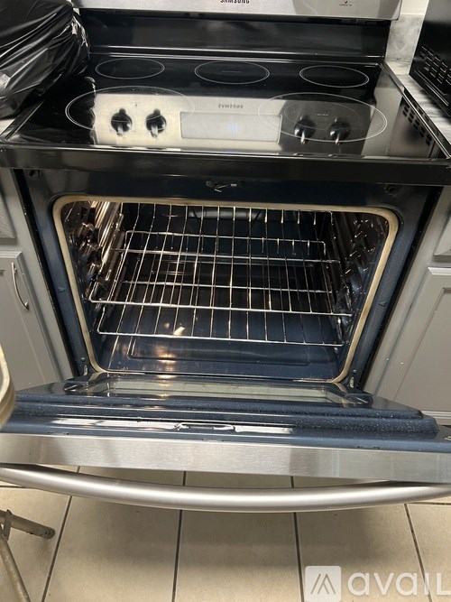 A modern oven with a stainless steel finish and a glass door.