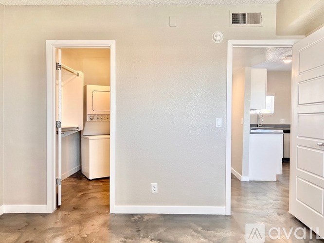 A kitchen with a white fridge and a white wall.