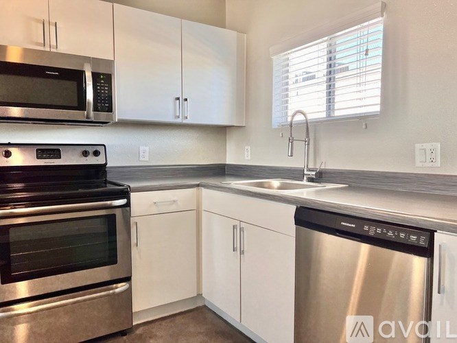 A kitchen with white cabinets and stainless steel appliances.