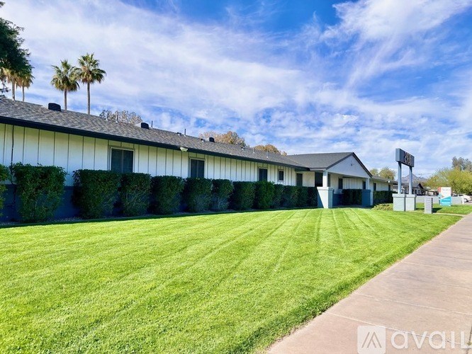 A row of houses with a grassy field in front.