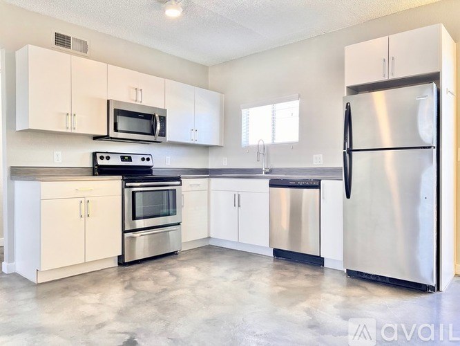 A kitchen with white cabinets and stainless steel appliances.