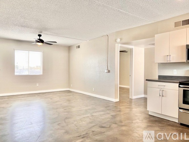 A spacious room with a fan and a window.