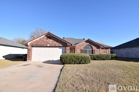 A house with a red brick exterior and a white garage door.