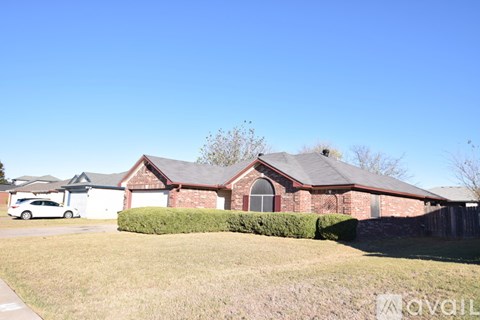 A house with a red roof and a white car parked in front.