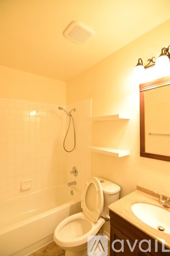 A bathroom with a toilet, sink, and bathtub.