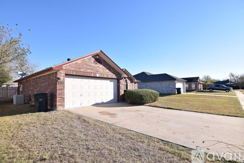 A house with a garage and a driveway in front.
