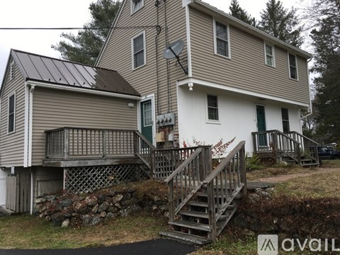 A house with a grey roof and a white door.