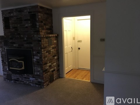 A room with a fireplace and a door.