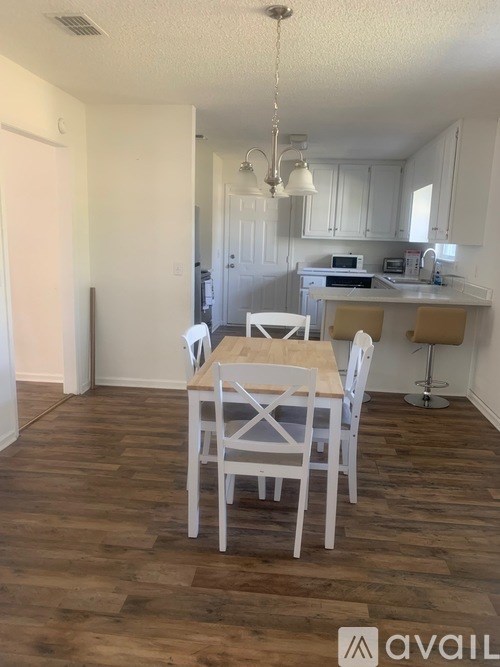 A kitchen with a table and chairs in the middle of the room.
