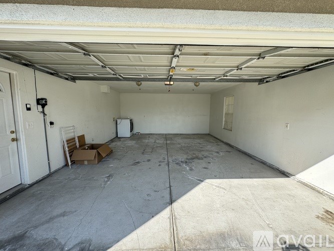 A spacious garage with a concrete floor and white walls.