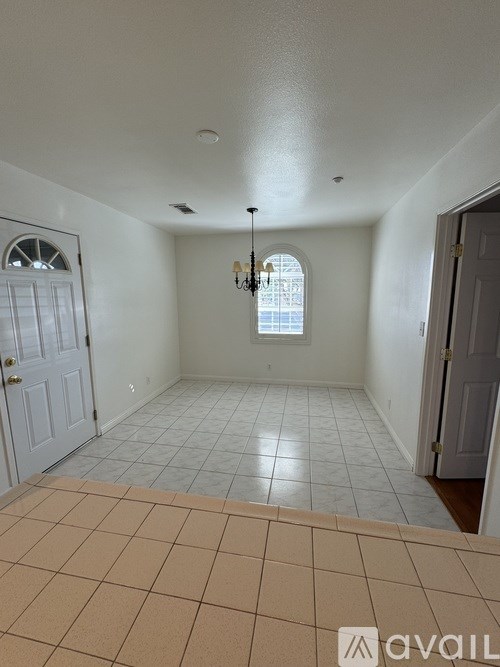 A room with a tiled floor and a chandelier.