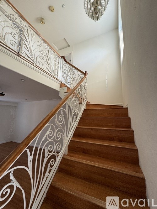 A staircase with a white railing and wooden steps.